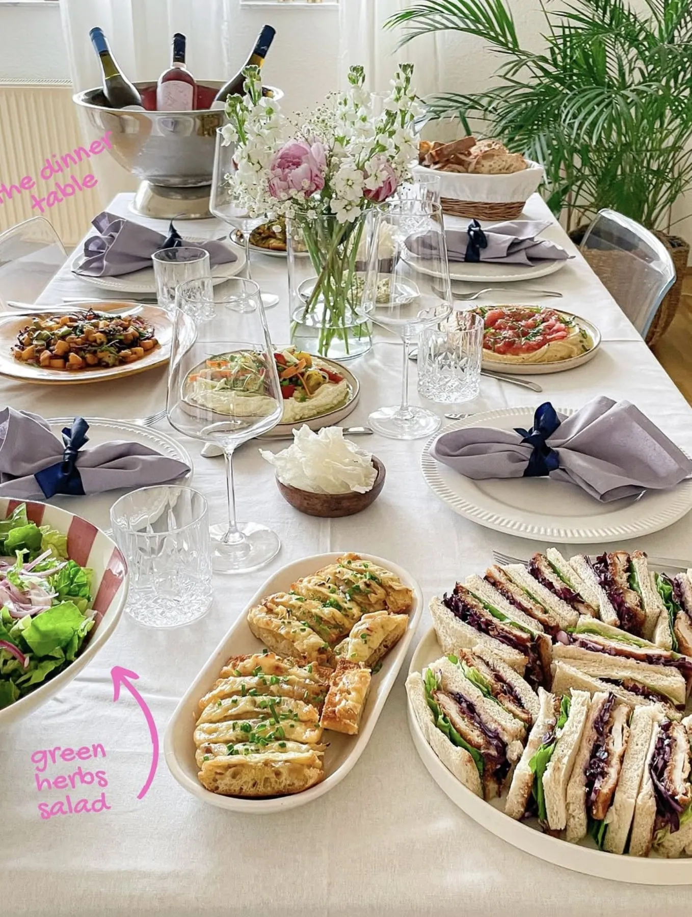 Kimberly’s brunch table with sandwiches, cheese rolls, salad and fresh flowers