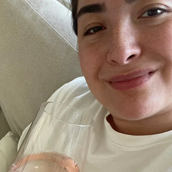 Kimberly on the sofa with a glass of rosé