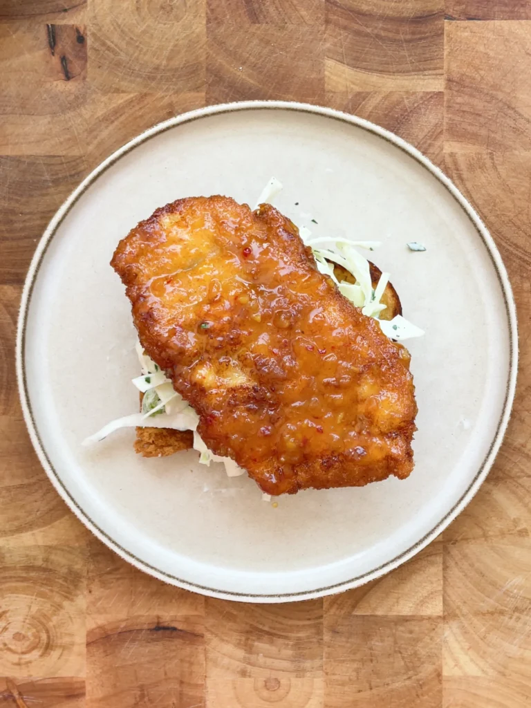 Crispy Sweet & Sour Chicken Brioche Sandwich with Yogurt Lime Slaw, ready to serve