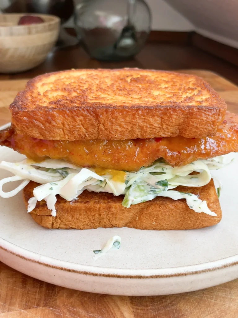 Crispy Sweet & Sour Chicken Brioche Sandwich with Yogurt Lime Slaw, ready to serve